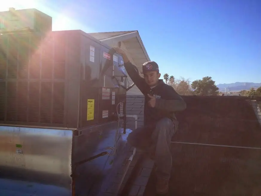 HVAC technician performing HVAC Inspection on a rooftop unit in Westgate